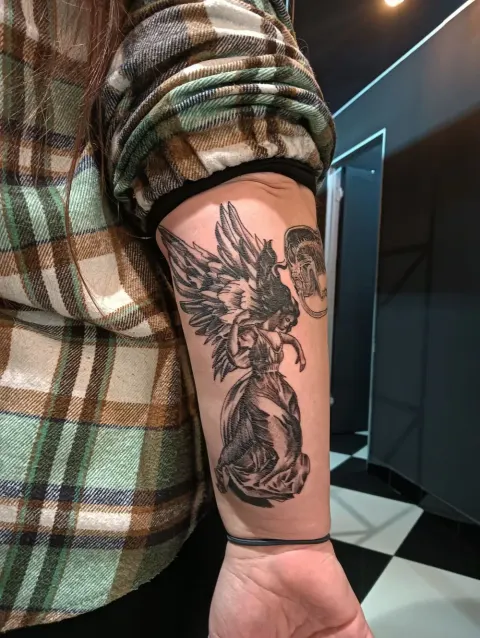 Winged angel, black and grey forearm tattoo, by Chad Solomon