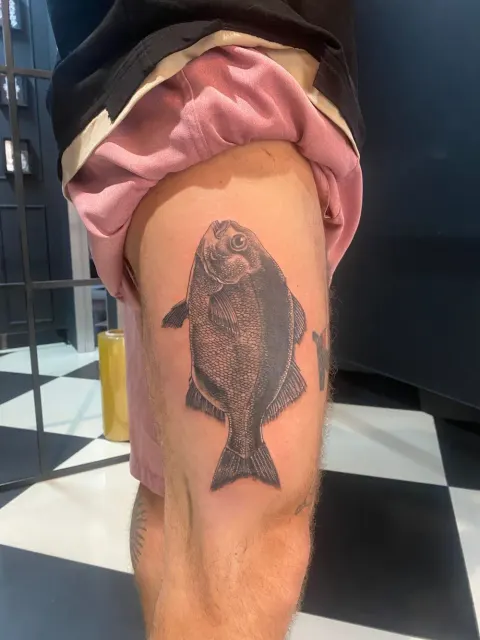 Fish tattoo on the back of the thigh, by Chad Solomon