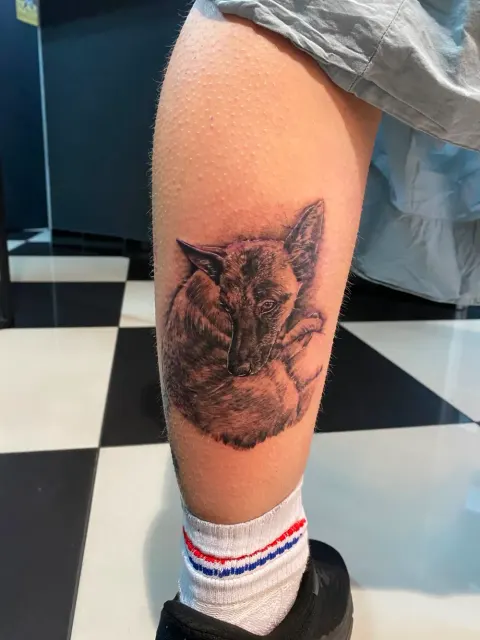Fox portrait tattoo on the calf, by Chad Solomon