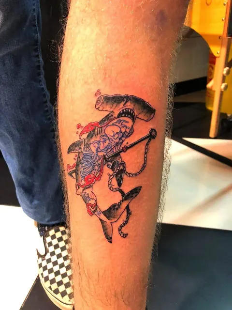 Hammerhead sharks with a skeleton and anchor chain, colour calf tattoo, by Chad Solomon
