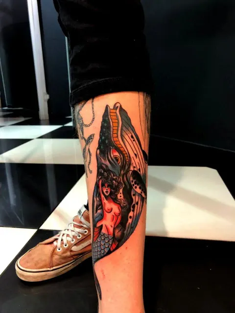 Mermaid with a humpback whale, colour calf tattoo, by Chad Solomon