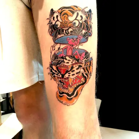 Neo-traditional tiger and diamond tattoo on the upper arm, by Chad Solomon