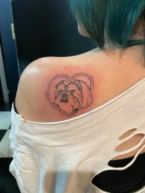 Pet dog portrait in a heart tattoo on the shoulder, by Chad Solomon