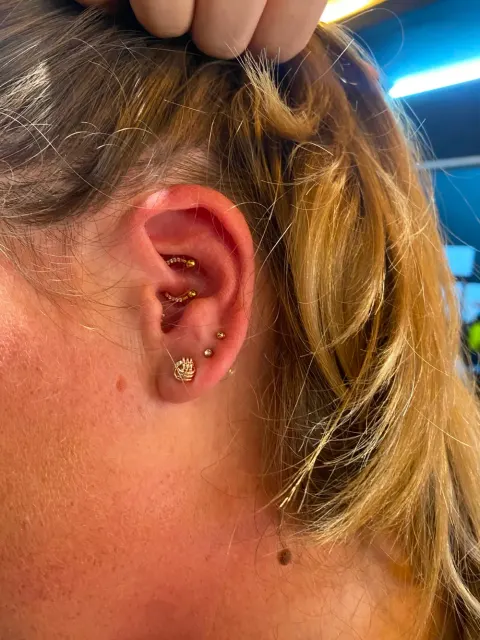 Daith and conch piercings, by Chandre Louw