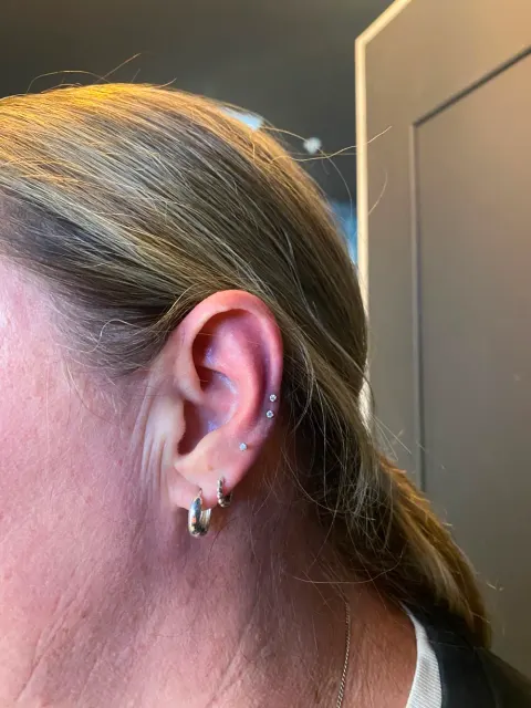 Double helix and lobe hoop piercings, by Chandre Louw