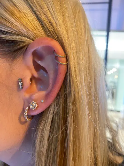 Double helix, tragus and lobe piercings, by Chandre Louw