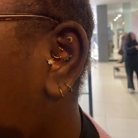 Gold daith, conch and lobe piercings, by Chandre Louw