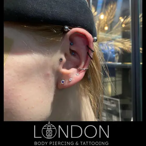 Industrial, helix and conch piercings, by Chandre Louw