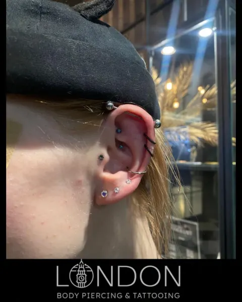Industrial, helix and conch piercings, by Chandre Louw