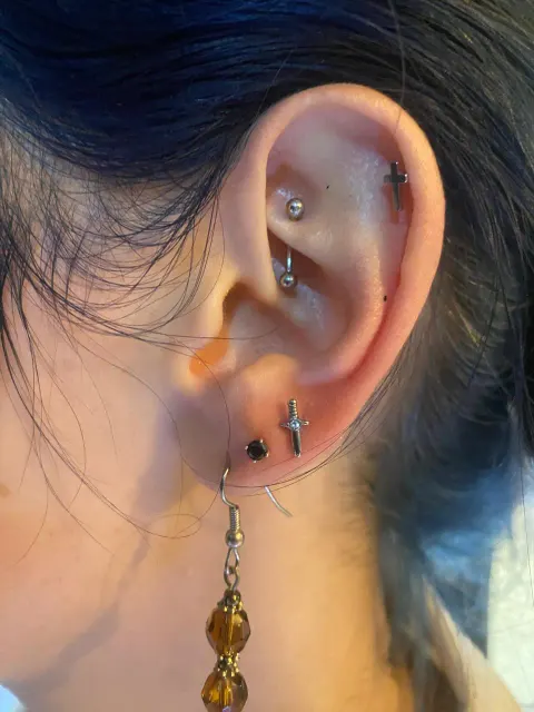 Rook, helix and lobe piercings, by Chandre Louw