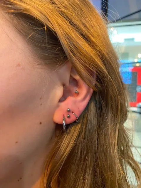 Stacked lobe hoops with a helix stud, by Chandre Louw