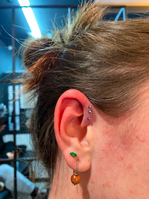 Triple helix piercing, by Chandre Louw