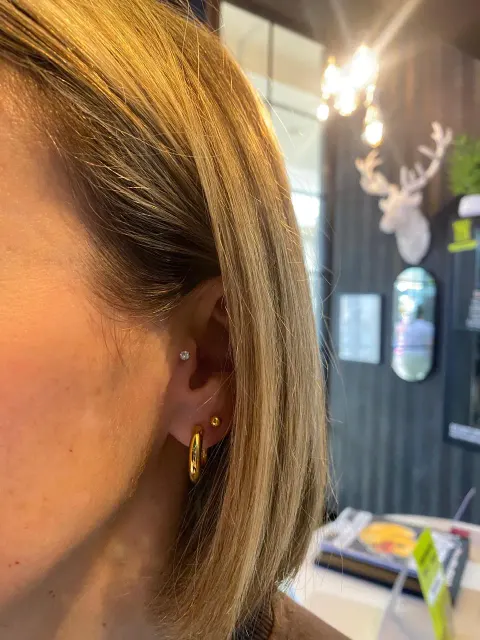 Upper lobe and lobe piercings, by Chandre Louw
