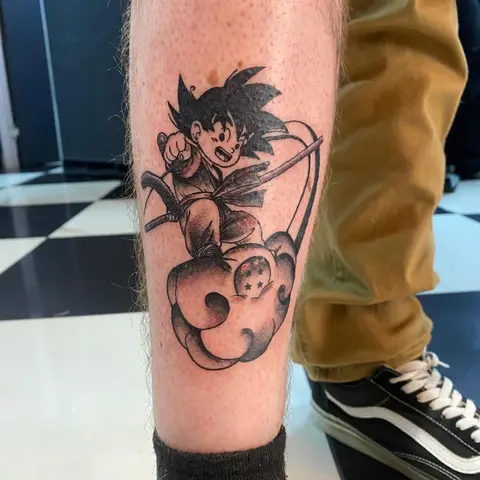Goku on the Flying Nimbus tattoo on the calf, by Kayla Grimwood