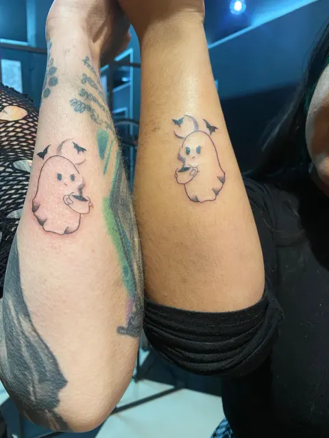 Matching ghost tattoos tattoo on the forearms, by Kayla Grimwood
