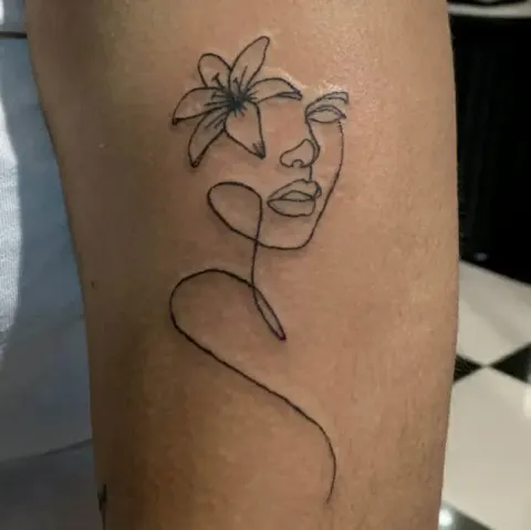 Single-line face with a lily tattoo, by Kayla Grimwood