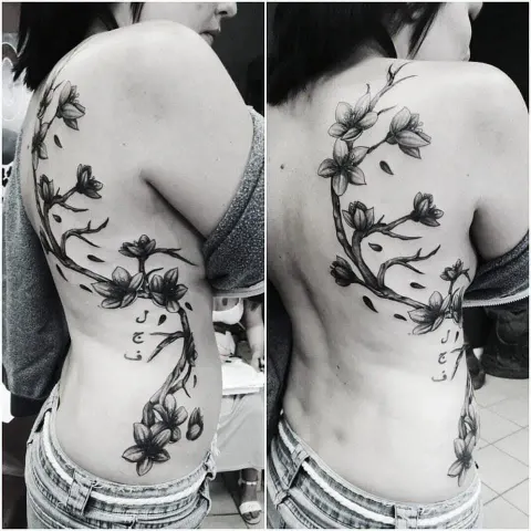 Cherry blossom branch tattoo running down the back and side, two angles, by Rob Turner