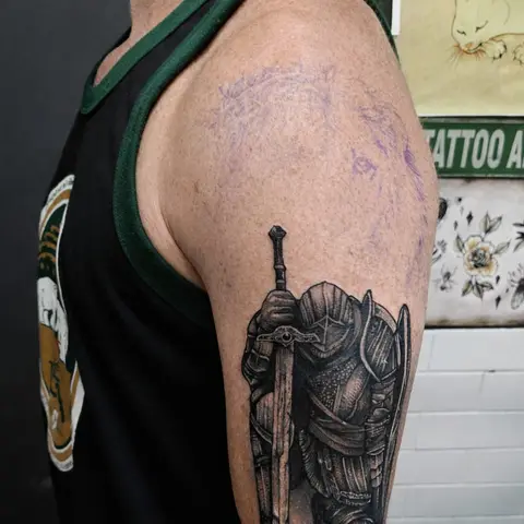 Armoured knight with a sword tattoo on the upper arm, by Rob Turner