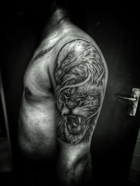 Lion and eagle tattoo on the shoulder and chest, by Rob Turner