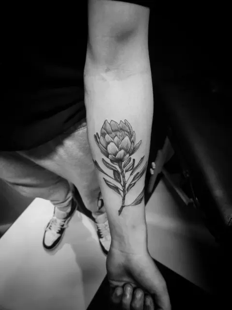 Protea flower tattoo on the forearm, by Rob Turner