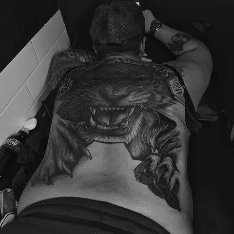Snarling tiger breaking through geometric patterns, full back piece tattoo, by Rob Turner