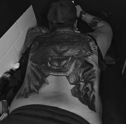 Snarling tiger breaking through geometric patterns, full back piece tattoo, by Rob Turner