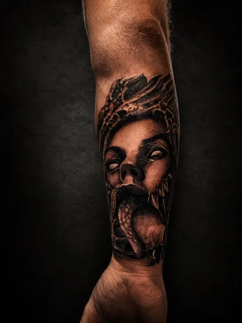 Woman's face with a snake, black and grey forearm tattoo, by Rob Turner