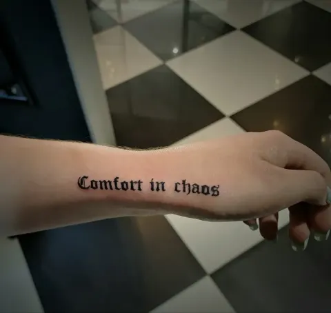 Comfort in chaos, gothic lettering along the side of the hand, by Tayla Symons