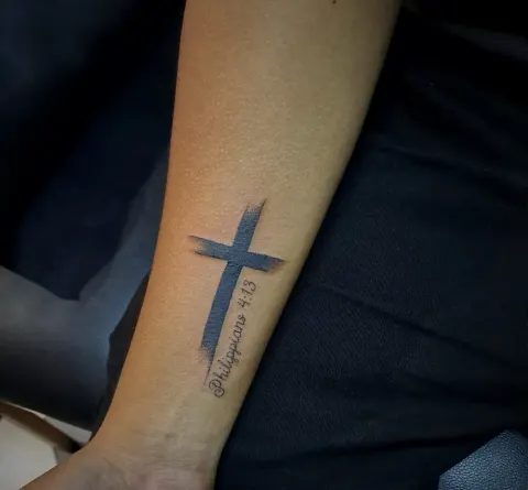 Brushstroke cross with Philippians 4:13 tattoo on the forearm, by Tayla Symons