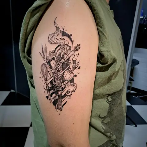 Geometric chef and kitchen composition tattoo on the upper arm, by Tayla Symons