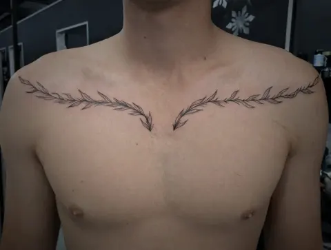 Fine line laurel branches across both collarbones, by Tayla Symons