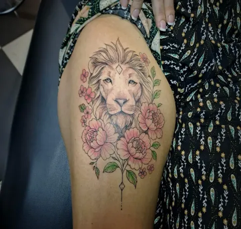 Lion with pink peonies and leaves, thigh tattoo, by Tayla Symons