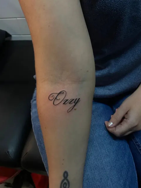 Name in script tattoo on the forearm, by Tayla Symons