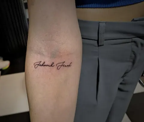 Names in script tattoo on the forearm, by Tayla Symons